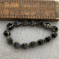8x10mm Faceted Bicone Black with a Picasso Finish and Gold Wash