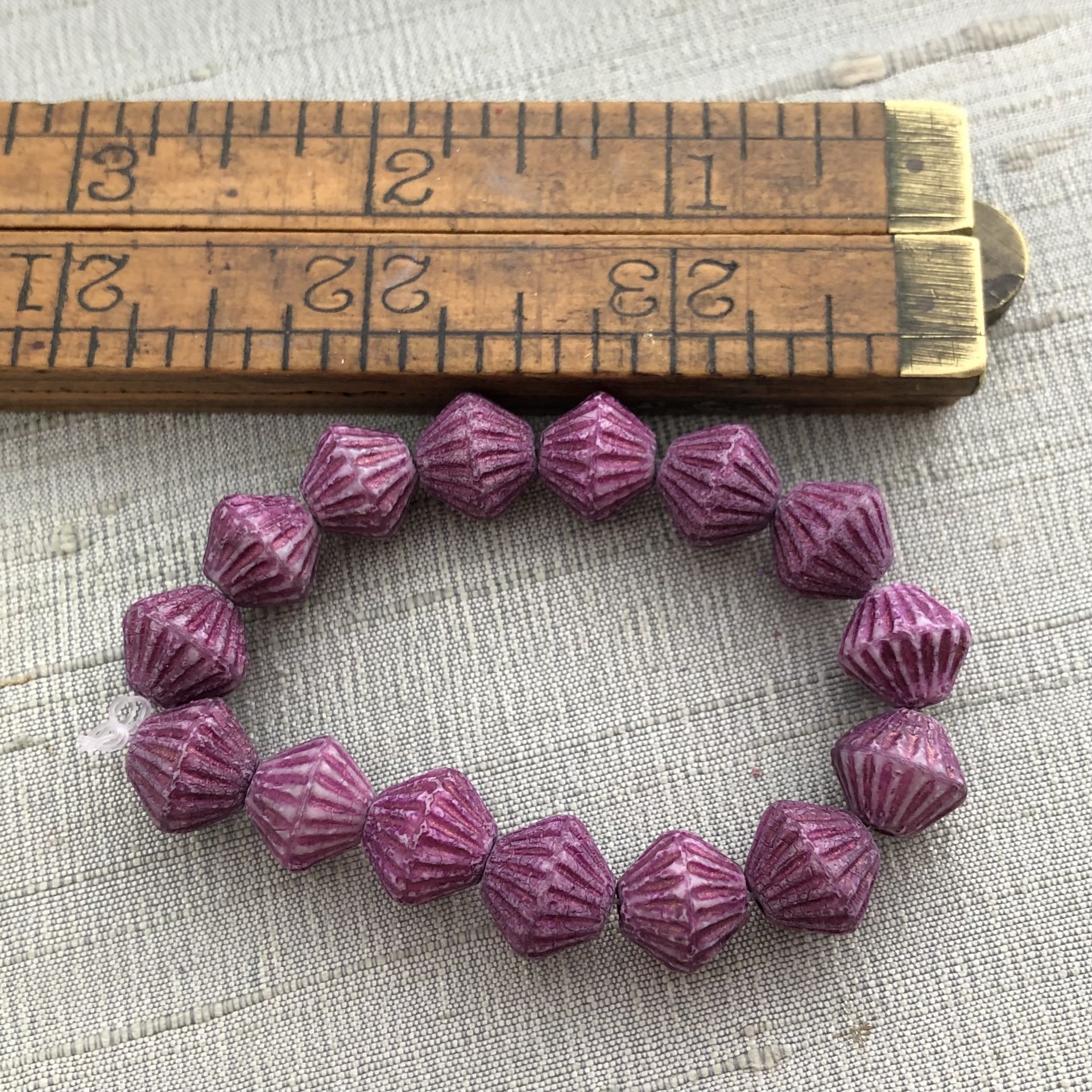 11mm Bicone Hyacinth with Etched Metallic Pink Wash